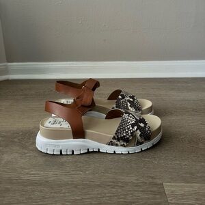 Brand new size 7 Cole Haan tan sandals with snake skin detailing.